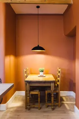 a dining room table with chairs and a pendant light at The Riverside Apartment (free parking) in Stirling