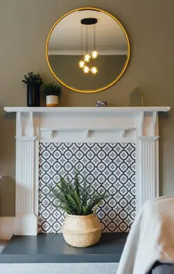 a white shelf with a mirror and a potted plant at The Riverside Apartment (free parking) in Stirling