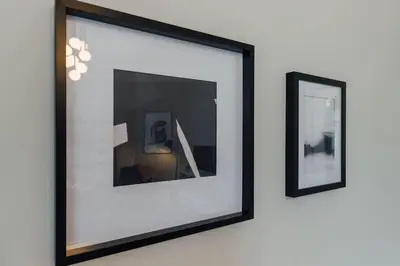 a framed picture on a wall with two pictures at Stylish Stirling Apartment - free parking in Stirling