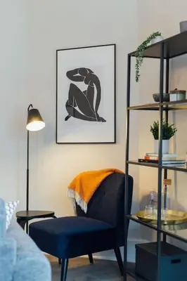 a living room with a blue chair and a shelf at Stylish Stirling Apartment - free parking in Stirling