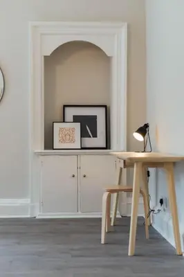 a room with a desk and a table with a lamp at Stylish Stirling Apartment - free parking in Stirling