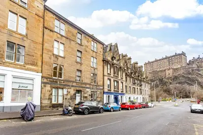 a street with cars parked on the side of the road at Open Plan 2 Bed Apt, Near Edinburgh Castle in Edinburgh