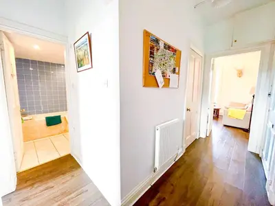 a room with a bathroom with a shower and a hallway at Open Plan 2 Bed Apt, Near Edinburgh Castle in Edinburgh