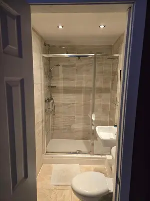 a bathroom with a shower and a toilet and a sink at The Braveheart House in Edinburgh