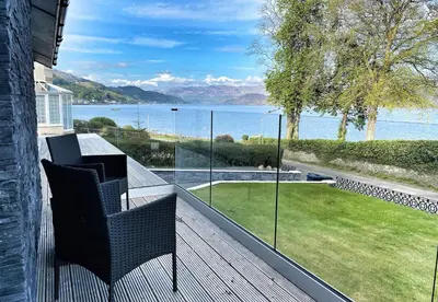 a balcony with a view of the water at The Lookout in Tighnabruaich