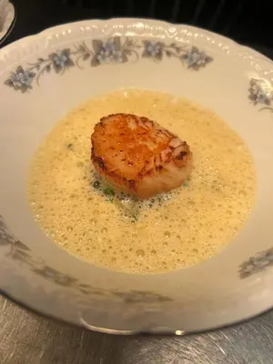 a plate with a piece of food in a sauce at Callander Meadows in Callander