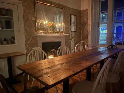 a dining room with a wooden table and chairs at Callander Meadows in Callander