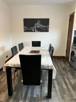a dining room with a table and chairs and a bridge at 4 bed bungalow near Airport in Edinburgh
