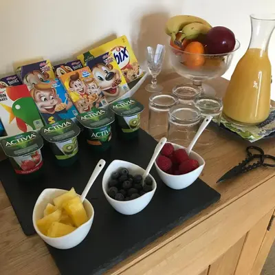 a table topped with bowls of fruit and juice at Cairnryan Bed and Breakfast in Cairnryan