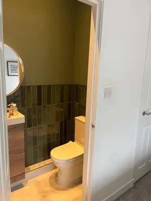 a bathroom with a toilet and a sink at Giffnock Rooms in Giffnock