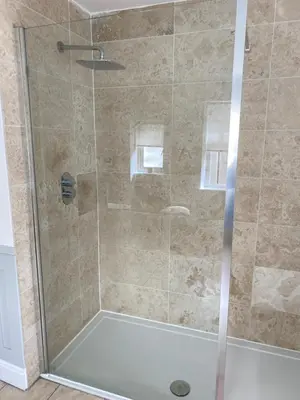 a shower stall with a glass door in a bathroom at Giffnock Rooms in Giffnock