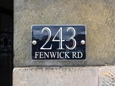 a street sign on the side of a building at Giffnock Rooms in Giffnock