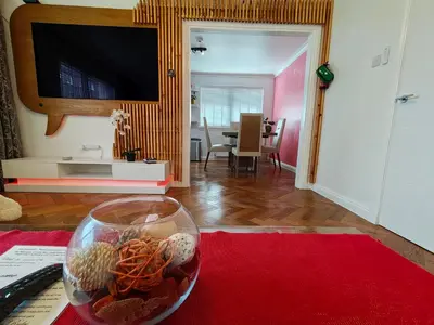 a living room with a vase with seashells on a table at Lovely 2 Bedroom Modern Ground Floor Flat in Clydebank
