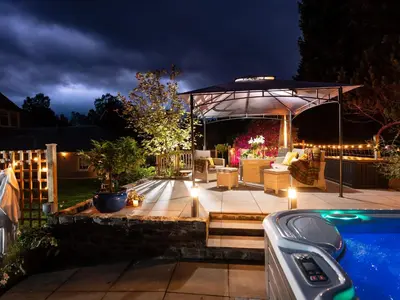 a backyard with a pool and a pavilion at night at The Bield in Aberfoyle