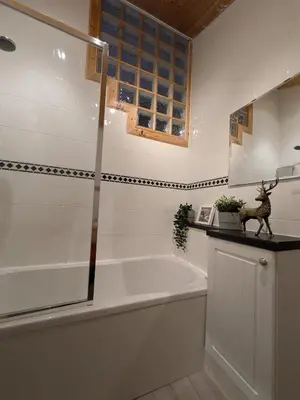 a bath tub in a bathroom with a window at Beautiful Upper Apartment/Stunning Sea Views, Isle of Bute in Port Bannatyne
