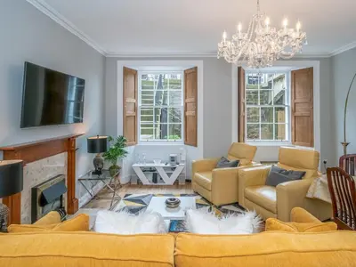 a living room with a couch and a fireplace at Superb 3Beds House in Chic area of the City Centre - Pass the Keys in Edinburgh