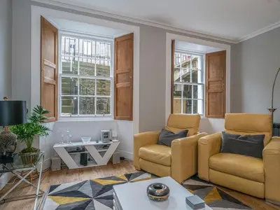 a living room with two chairs and a table at Superb 3Beds House in Chic area of the City Centre - Pass the Keys in Edinburgh
