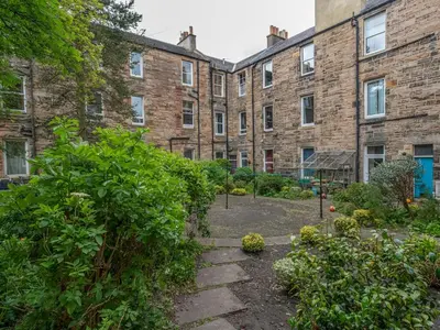 a garden in front of a brick building at Superb 1 Bed Flat in Traditional Victorian Building - Pass the Keys in Edinburgh