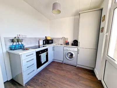 a kitchen with a sink and a washing machine at Three Bridges Waterfront in North Queensferry