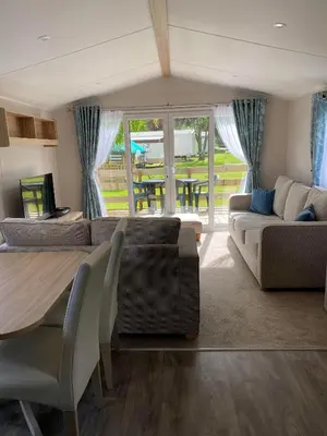 a living room with a couch and a table and chairs at Malton 74 in Dunoon