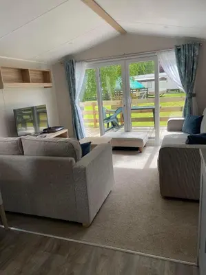 a living room with two couches and a large window at Malton 74 in Dunoon