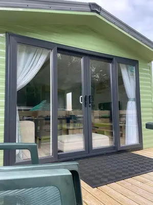 a conservatory with sliding glass doors on a house at Malton 74 in Dunoon