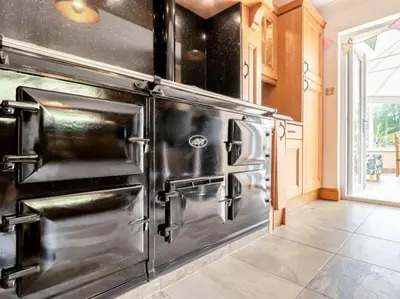 a large kitchen with stainless steel appliances at 3 Bedroom luxury home, hot tub, stunning views of Killin, sitting on the River Dochart in Killin