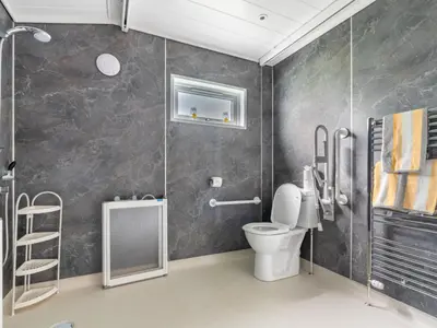 a bathroom with a toilet and a walk in shower at Chalet Loch Leven Lodge 16 Robin's Nest by Interhome in Kinross