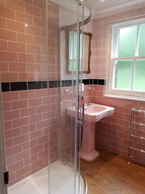 a bathroom with a glass shower and a sink at Beautiful Traditional secluded country cottage in Sanquhar