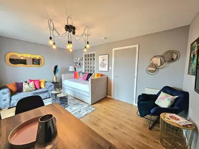 a living room with a couch and a table at 4 Separate Beds, Sleeps 6, Beautiful 2 bed Apt in Edinburgh
