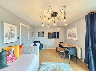 a living room with a bed and a desk in it at 4 Separate Beds, Sleeps 6, Beautiful 2 bed Apt in Edinburgh
