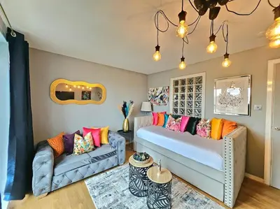 a living room with a bed and a couch at 4 Separate Beds, Sleeps 6, Beautiful 2 bed Apt in Edinburgh