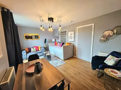 a living room with a table and a couch at 4 Separate Beds, Sleeps 6, Beautiful 2 bed Apt in Edinburgh