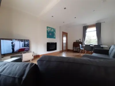 a living room with a couch and a flat screen tv at Carvetii - Xavier House - 2-storey sleeps up to 7 in Rosyth