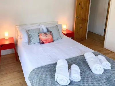 a bedroom with a bed with towels on it at Mill Court in Dunblane