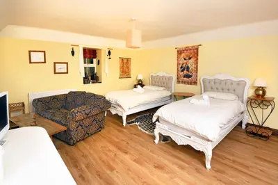 a living room with two beds and a couch at Craigadam Lodge with Hot tub in Castle Douglas