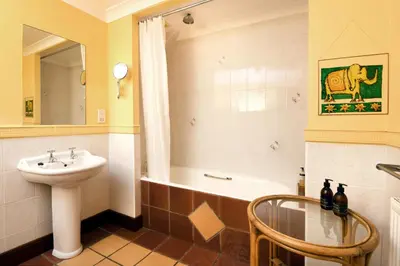 a bathroom with a sink and a toilet and a tub at Craigadam Lodge with Hot tub in Castle Douglas