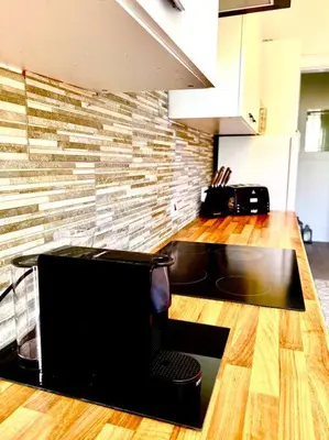 a kitchen with a counter with a microwave and a counter top at Historic 2-Bed Paisley Retreat, Airport & Station in Paisley