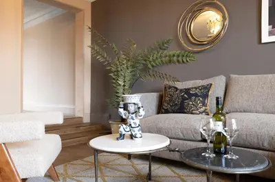 a living room with a couch and a table at 30 Castle Street Aparthotel in Edinburgh