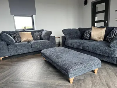 a living room with two couches and a ottoman at Machrie View in Port Ellen