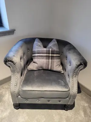 a leather couch with a pillow on top of it at Machrie View in Port Ellen