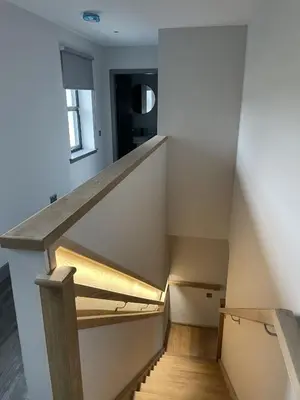 a staircase in a house with wooden floors at Machrie View in Port Ellen