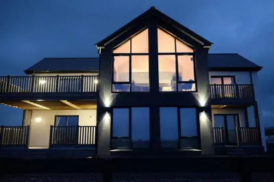 a house with large windows on the side of it at Machrie View in Port Ellen