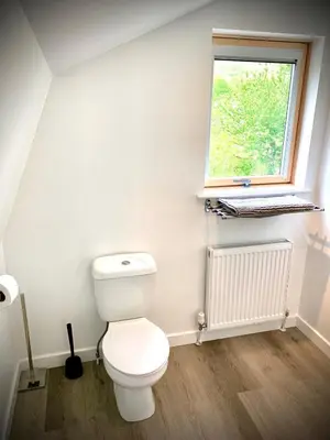 a bathroom with a toilet and a window at Glamping at Shieling Holidays Mull in Craignure