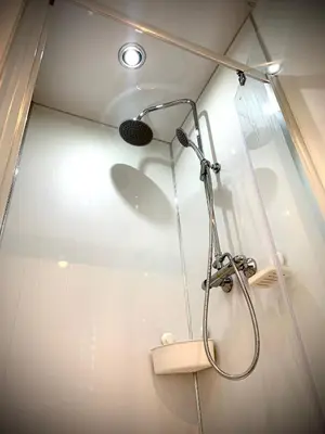 a shower with a shower head in a bathroom at Glamping at Shieling Holidays Mull in Craignure