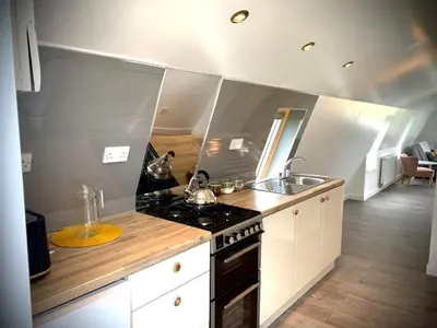 a small kitchen with a stove and a sink at Glamping at Shieling Holidays Mull in Craignure