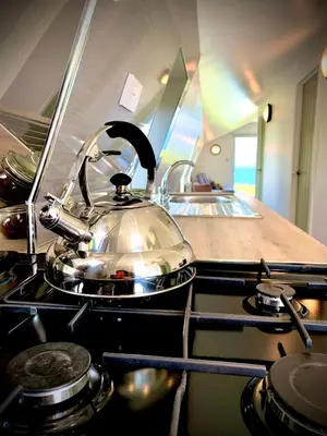 a tea kettle sitting on top of a stove in a kitchen at Glamping at Shieling Holidays Mull in Craignure