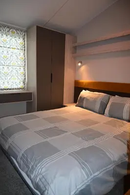 a large bed in a bedroom with a window at Muasdale - Shore View in Muasdale