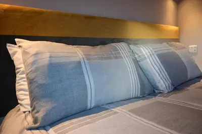 a bed with two pillows on top of it at Muasdale - Shore View in Muasdale
