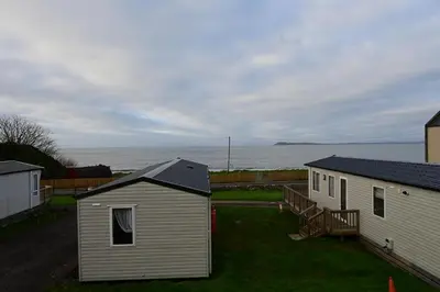 a group of buildings with the ocean in the background at Muasdale - Shore View in Muasdale